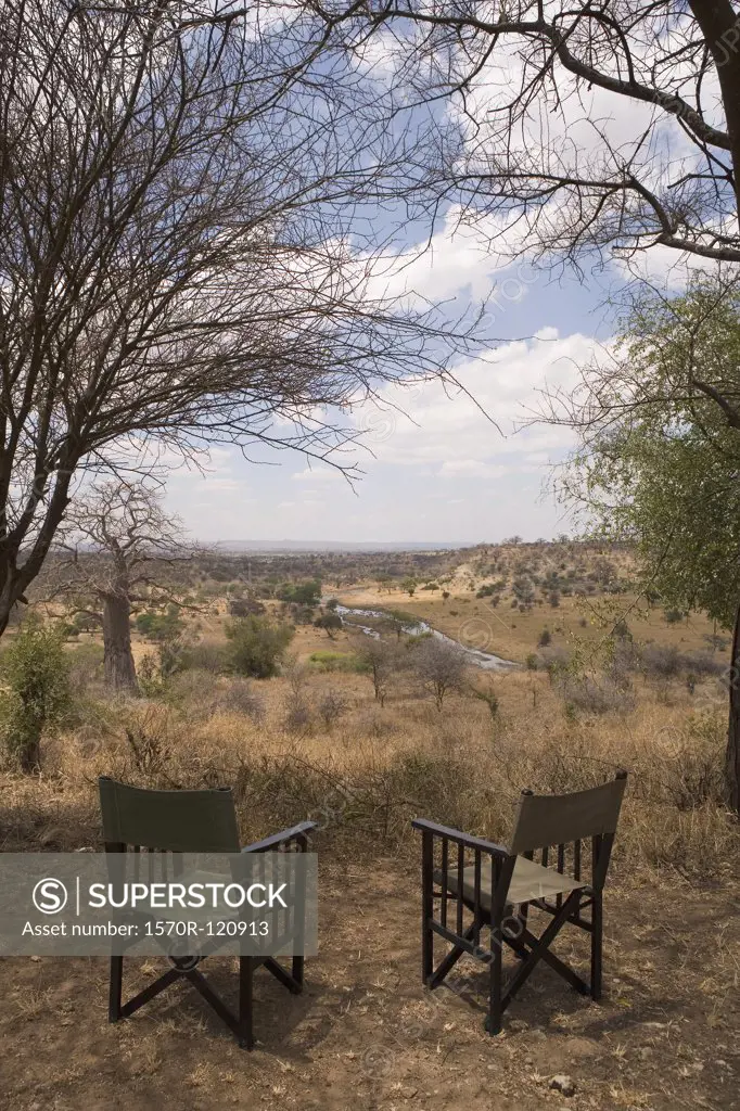 Two empty chairs overlooking African landscape