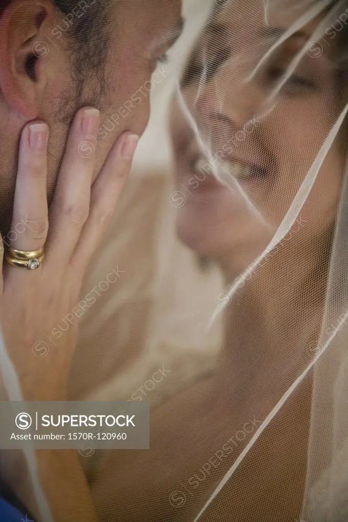 Close-up of a bride and a groom embracing