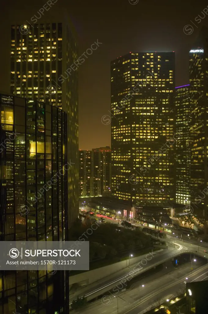 Illuminated skyscrapers and highway at night, Los Angeles, California