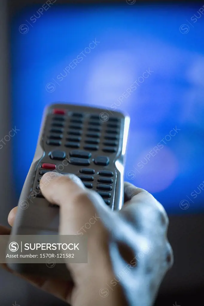 Hand holding a remote control