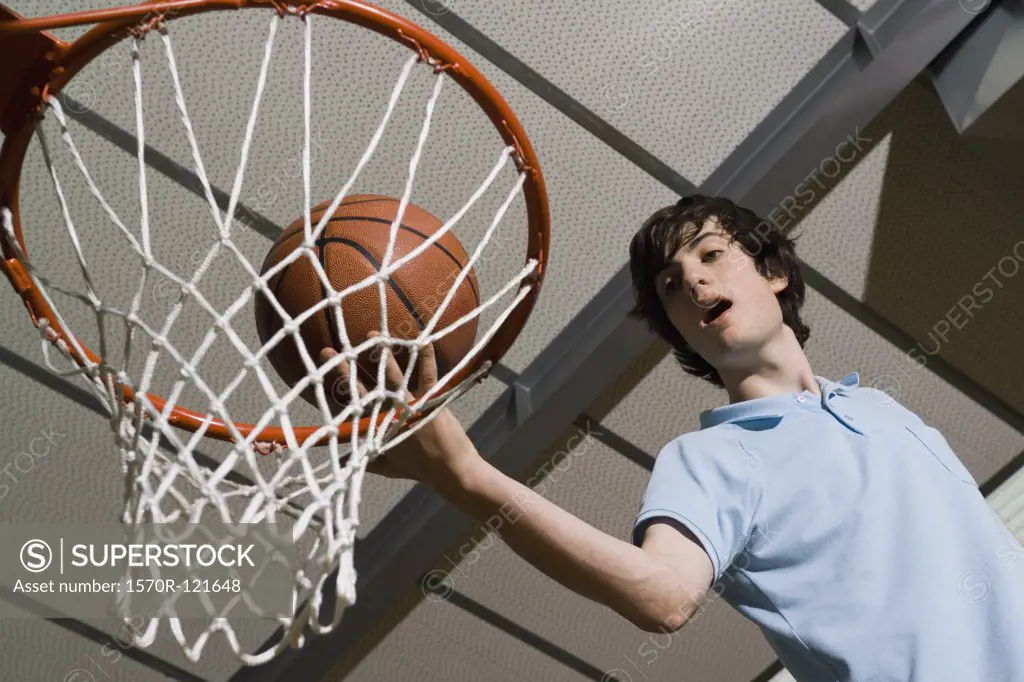 A man standing above a basketball hoop