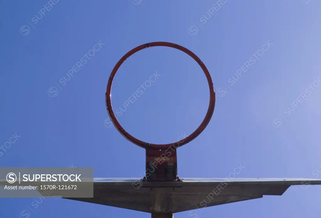 low angle view through a basketball hoop of the sky
