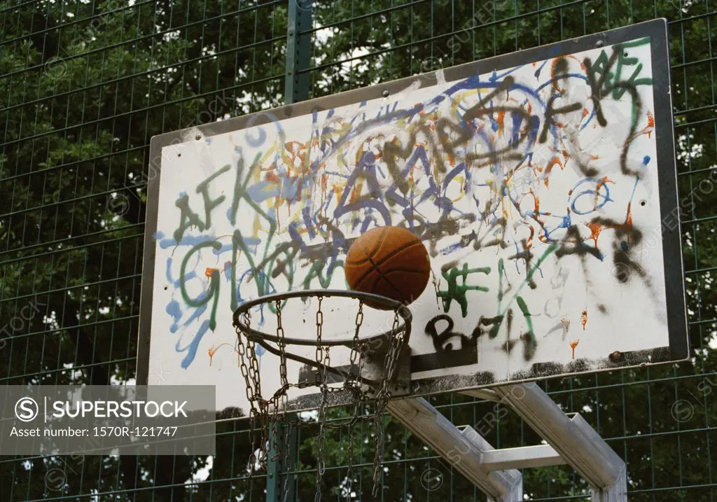 Basketball going into a basketball hoop