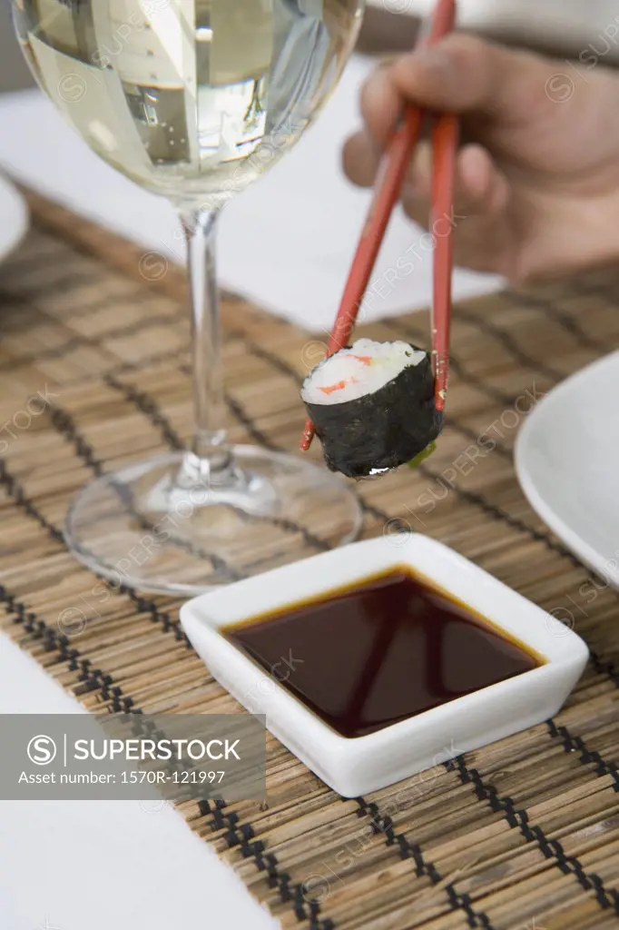 Sushi, soy sauce and a glass of wine