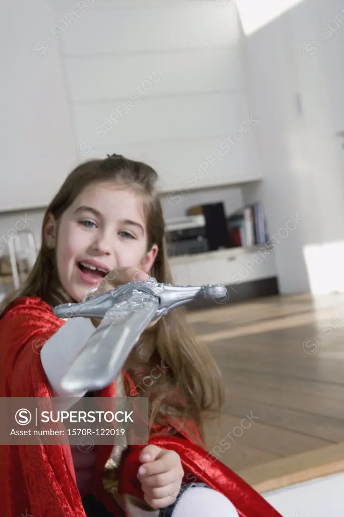 A little girl holding a toy sword