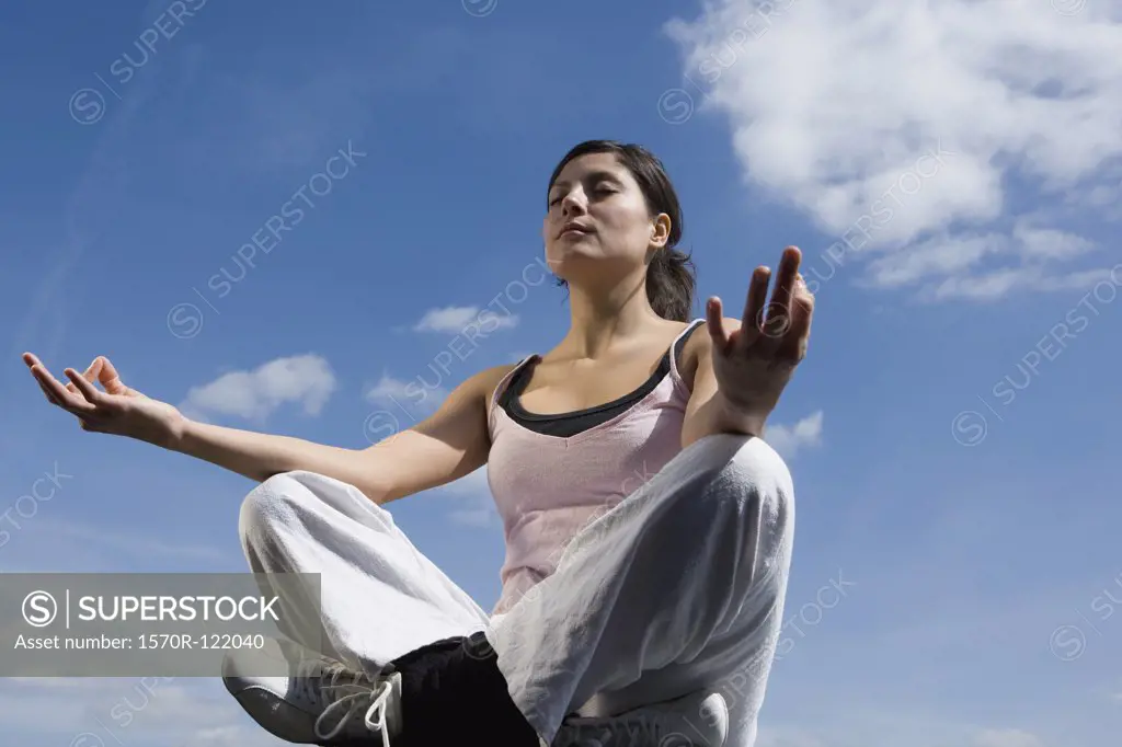 A young woman meditating