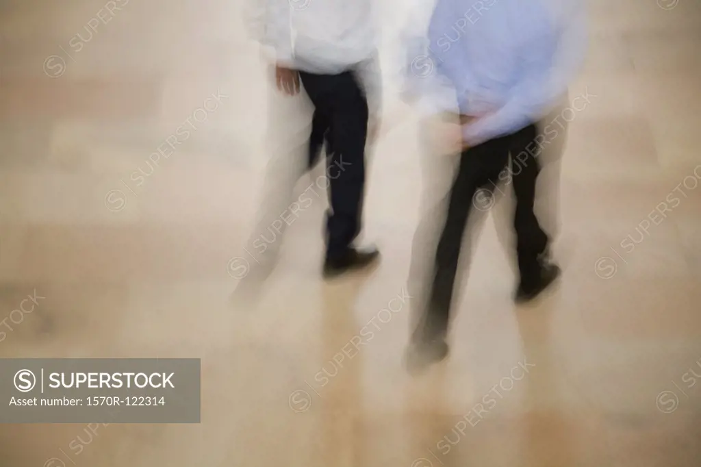 Blurred view of two men walking