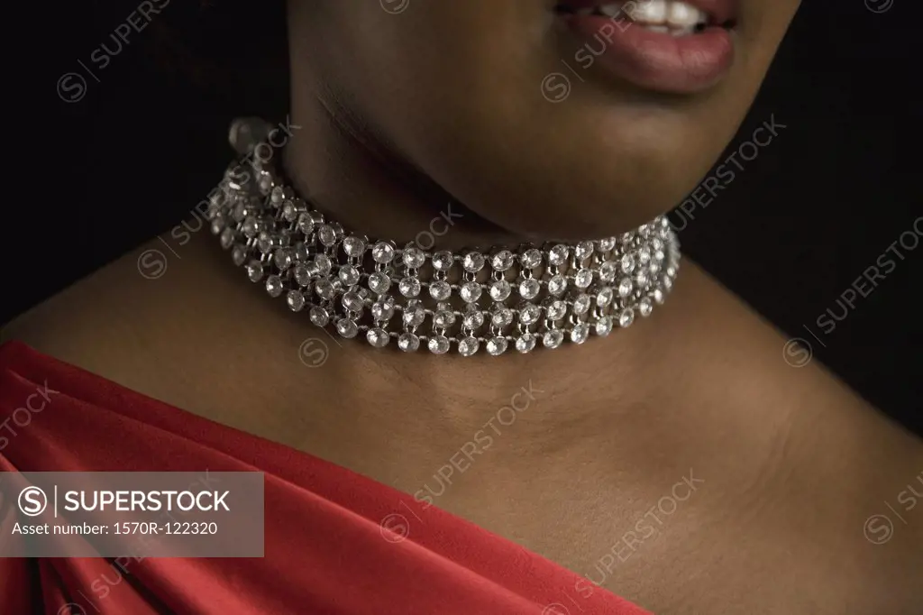 A woman wearing a diamond necklace