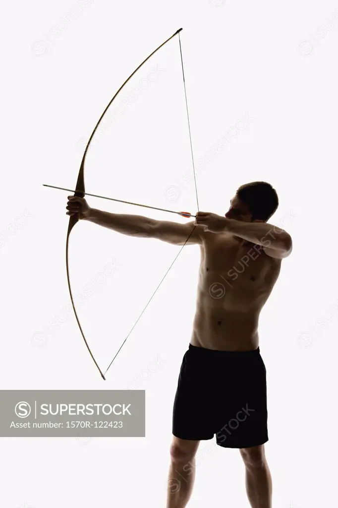 Silhouette of archer pulling an arrow back on his longbow