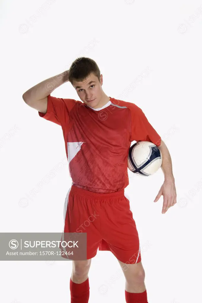 studio Portrait of a soccer player holding a soccer ball
