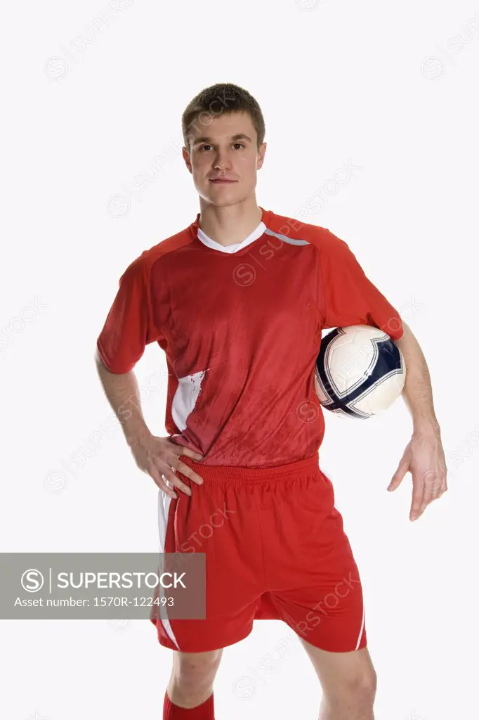 studio Portrait of a soccer player holding a soccer ball