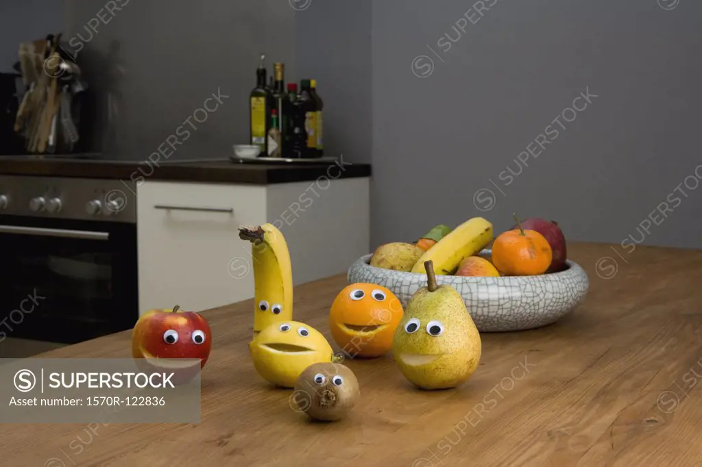 Fruit with smiley faces on a kitchen table