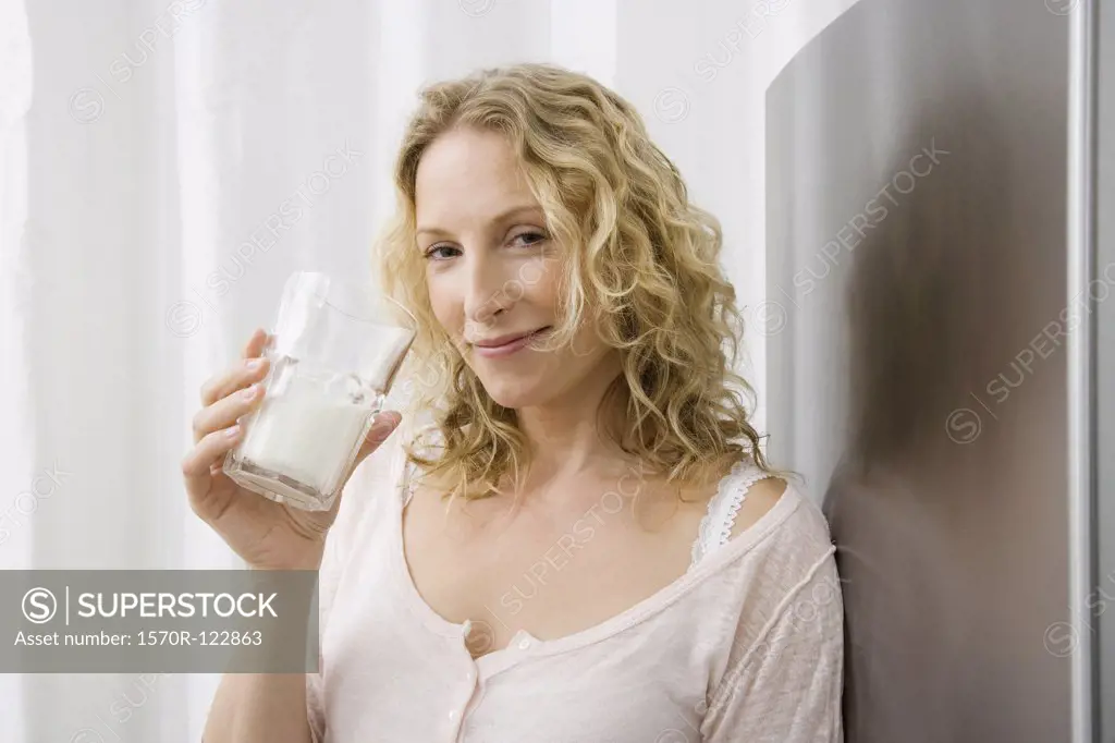 A woman drinking a glass of milk