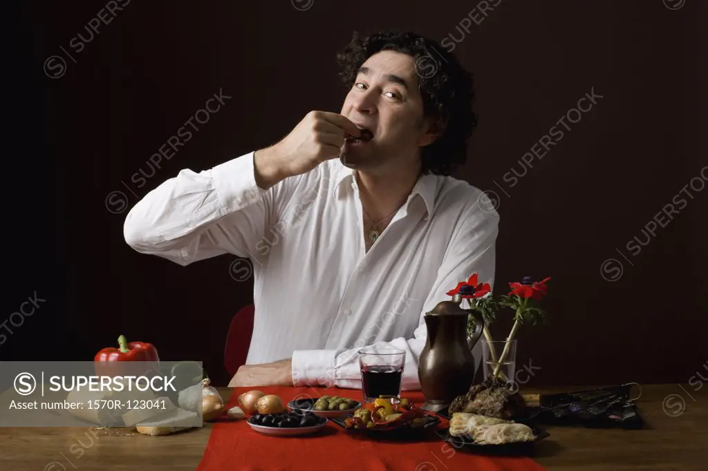 Stereotypical Spanish man eating tapas