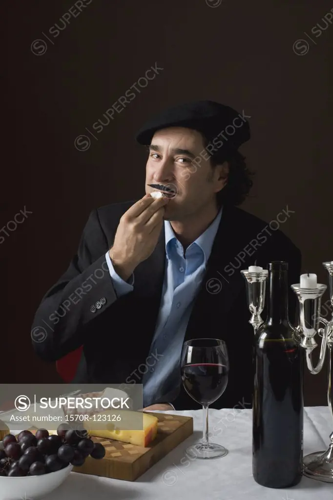 Stereotypical French man tasting French cheese