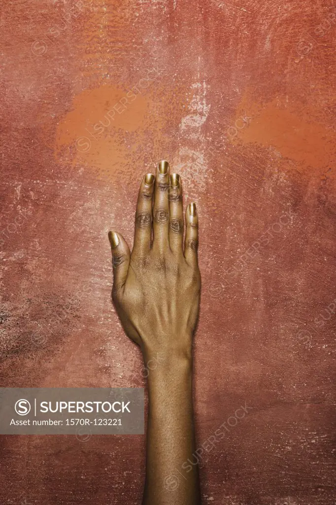 A woman's hand in front of a wall