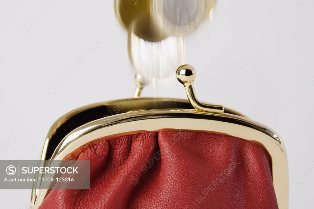 Coins falling into a purse