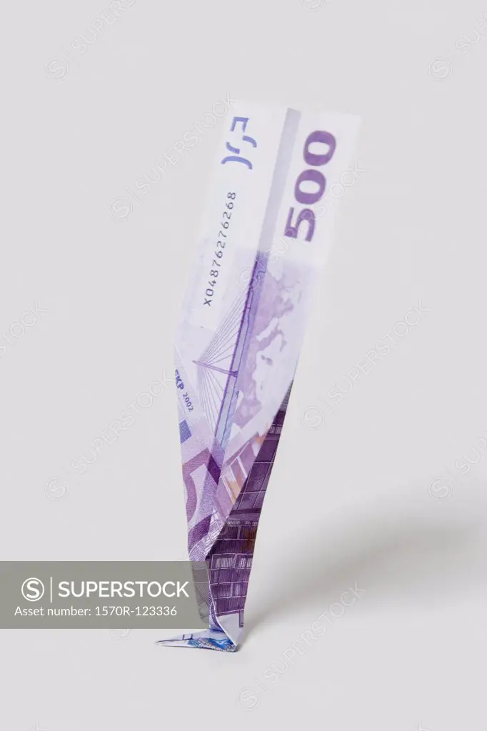 A paper airplane made from a five hundred euro banknote crashed on its nose