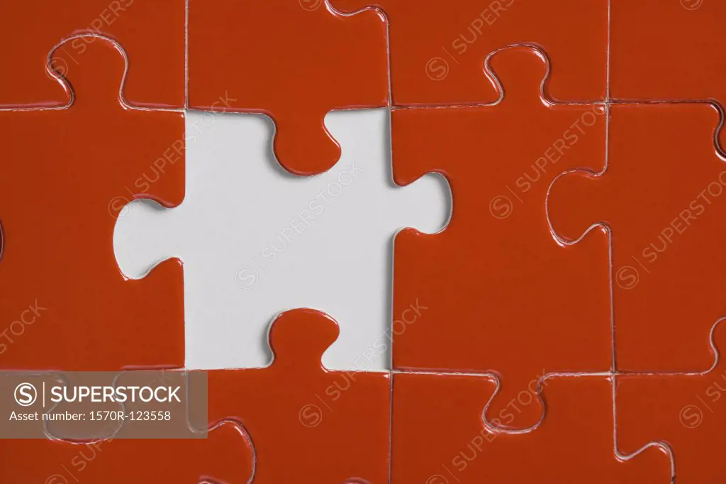 Missing piece in a red jigsaw puzzle
