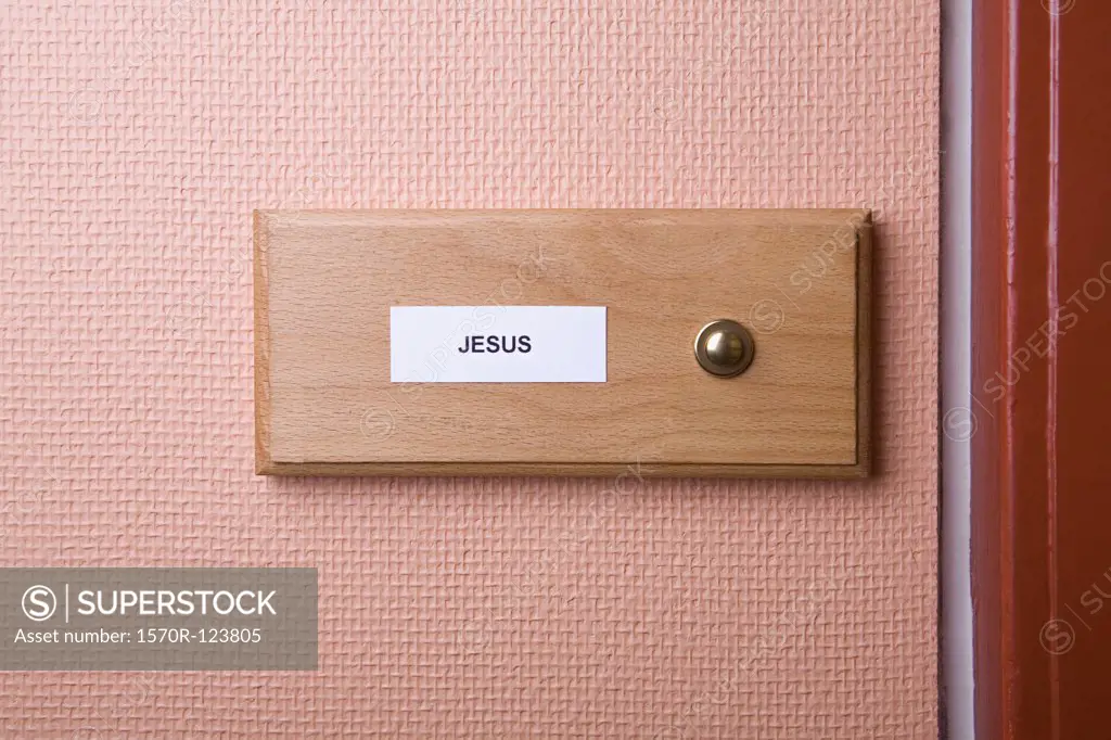 'Jesus' name sticker next to doorbell