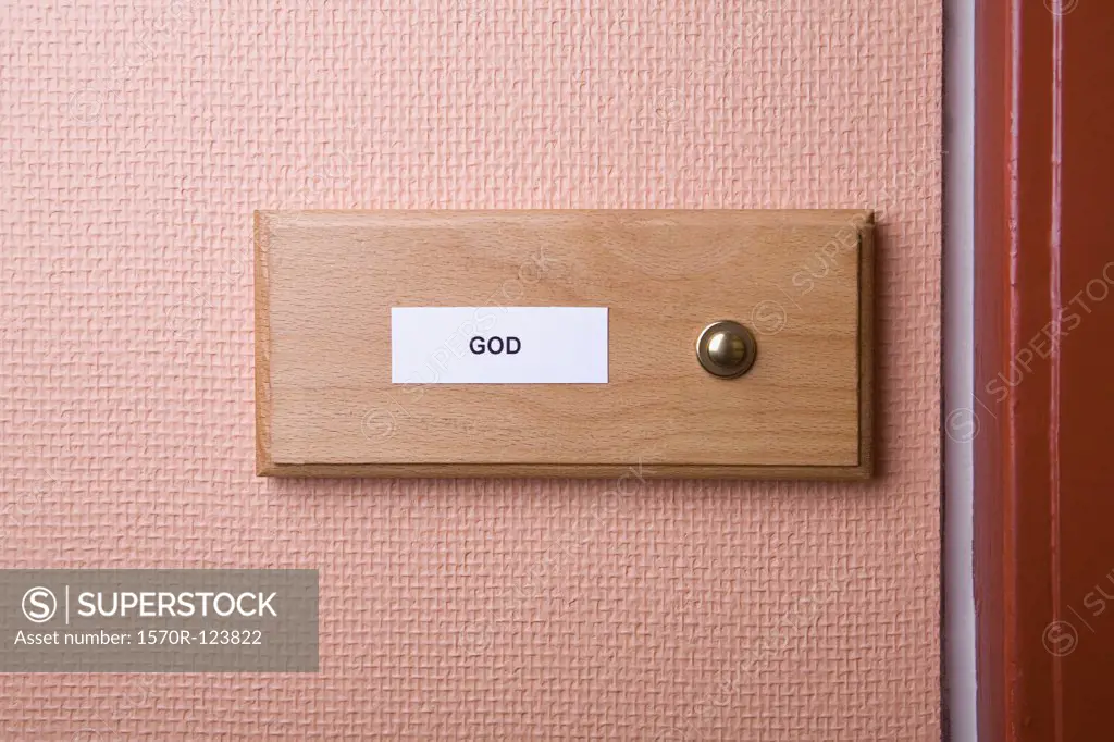 'God' name sticker next to doorbell