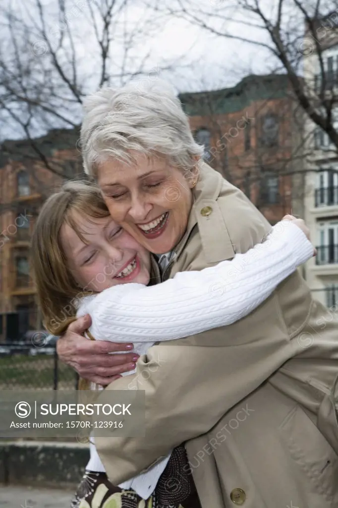 A grandmother and granddaughter hugging