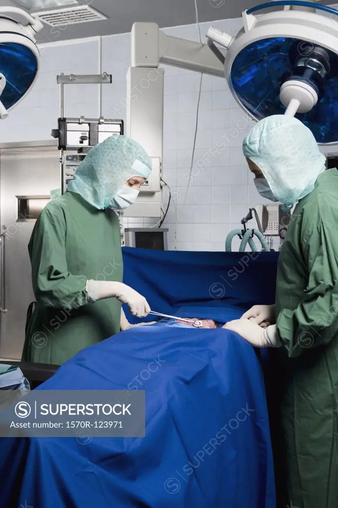 Two surgeons operating on a patient