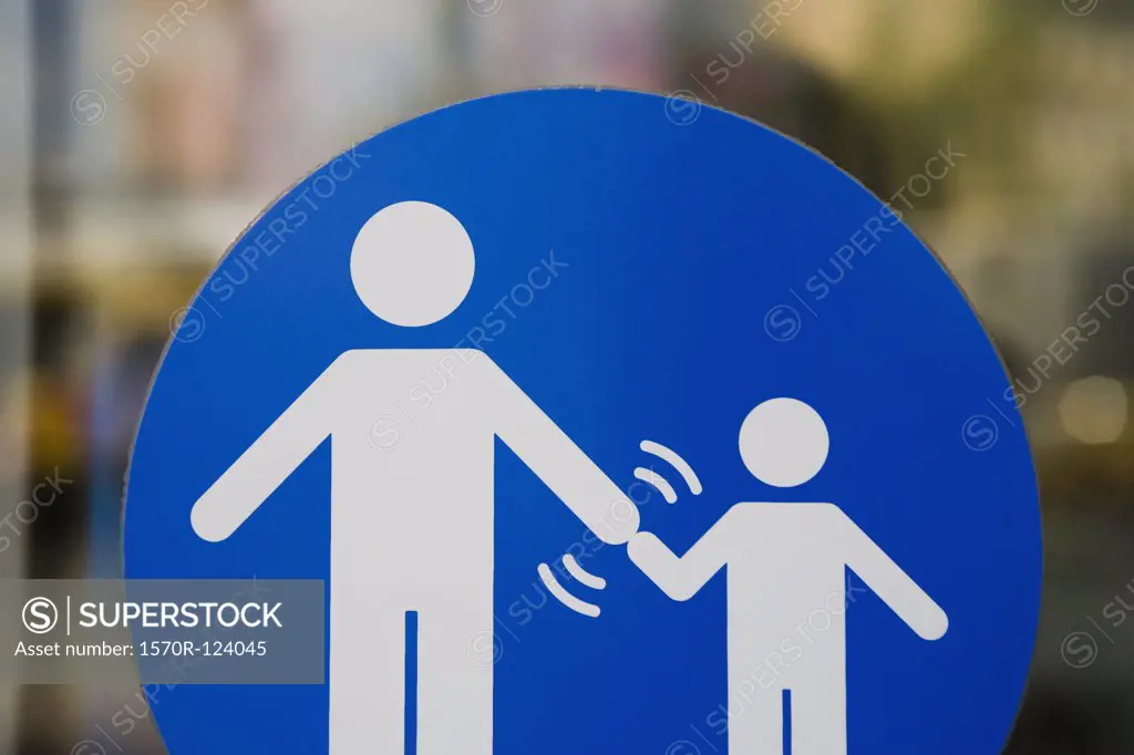 A crossing sign that indicates adults must hold a child's hand