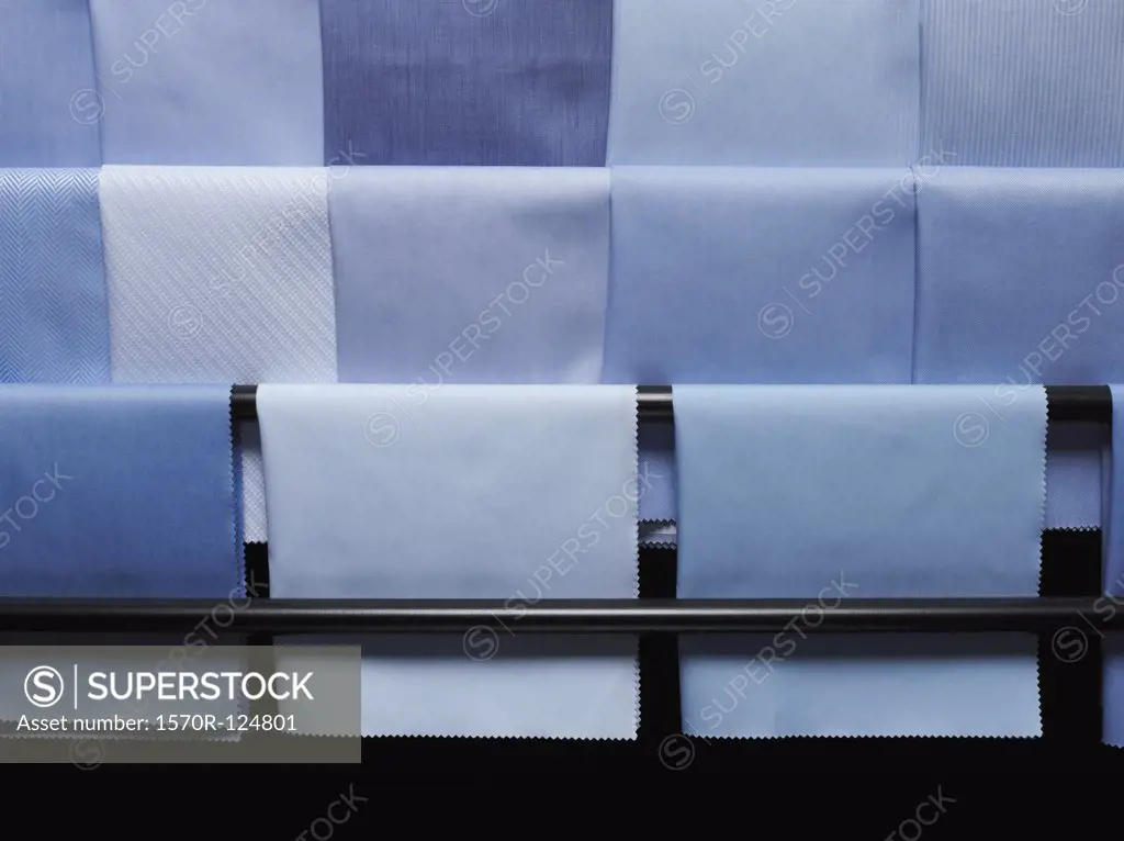 Blue fabric swatches on a rack