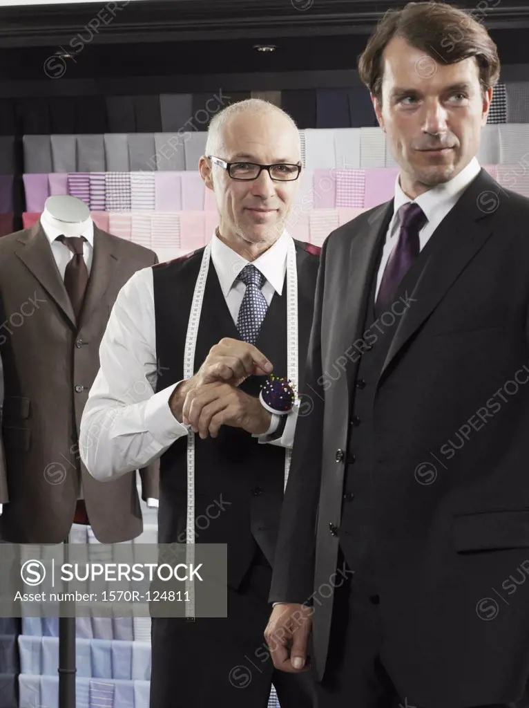 A tailor fitting a man with a suit