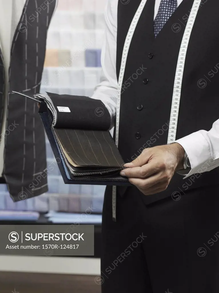 A tailor with samples of fabric