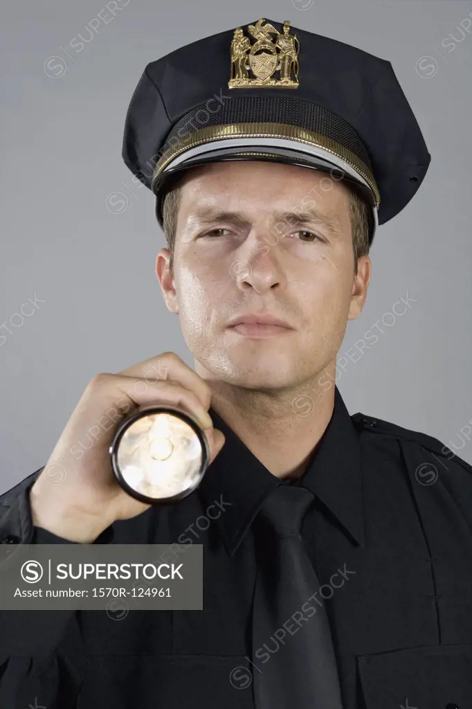 Portrait of a police officer holding a torch