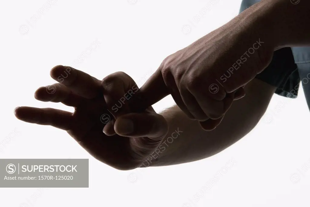Hands making a sexual gesture