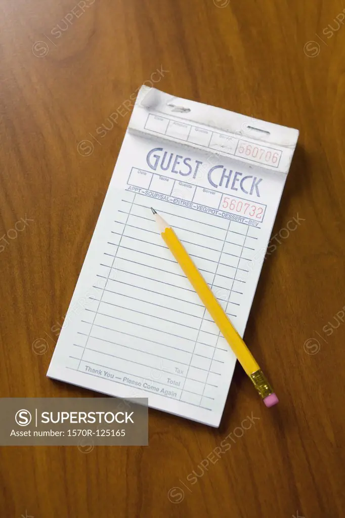 A guest check order pad and pencil