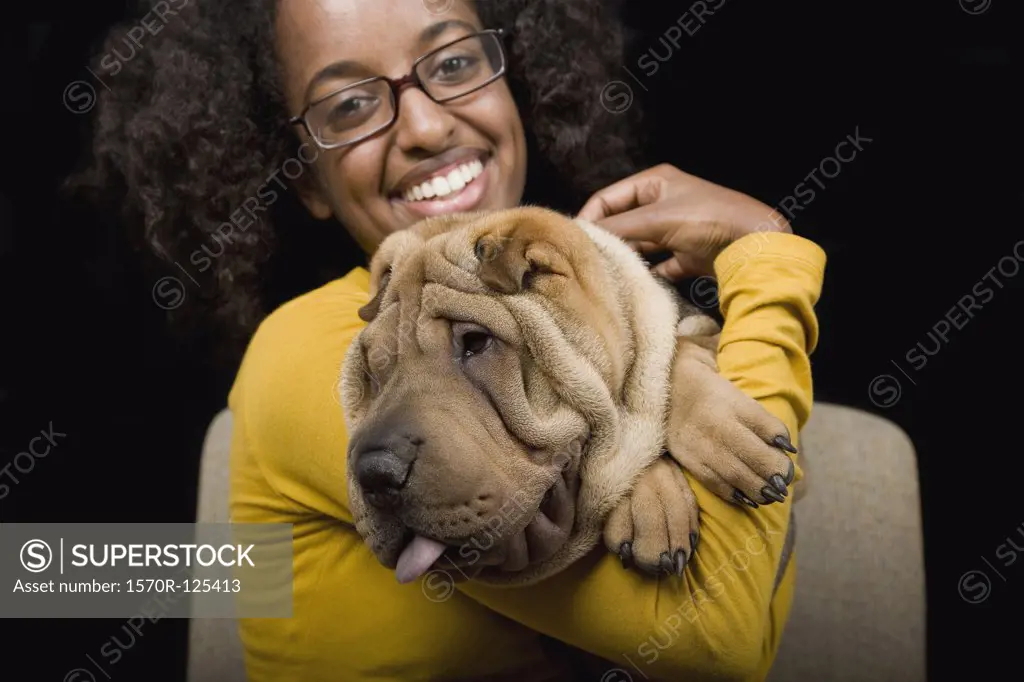 A young woman with her Shar-Pei, studio shot