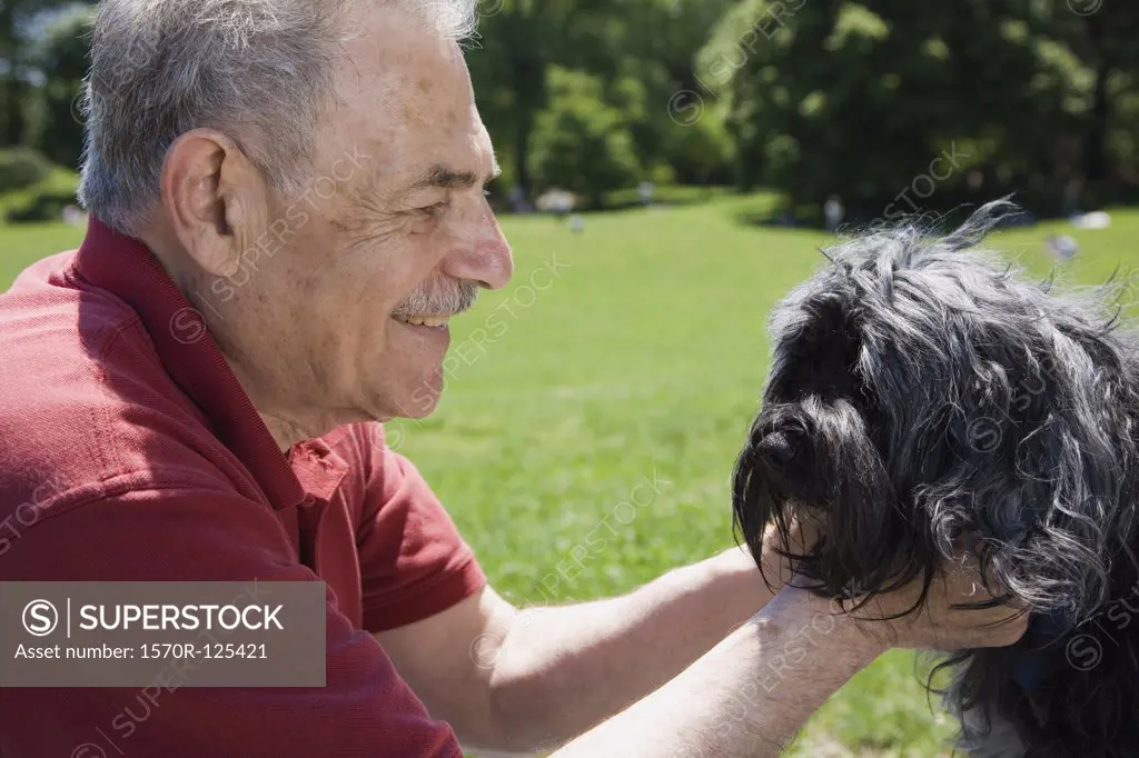 A man and his dog in a park, face to face, Prospect Park, Brooklyn, New York, USA