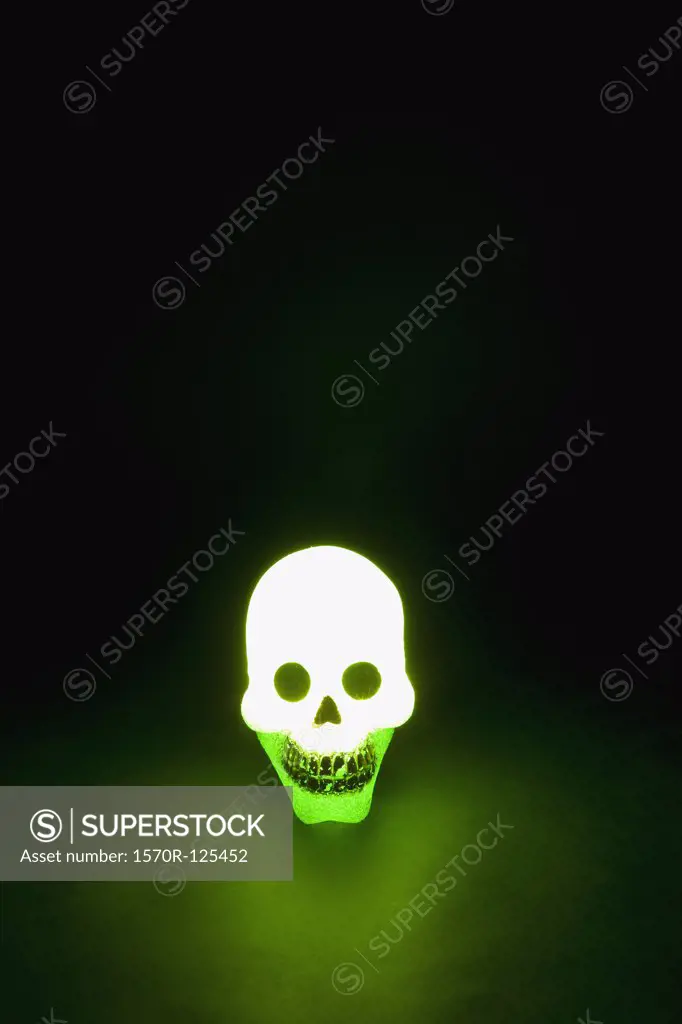 A skull illuminated in green light
