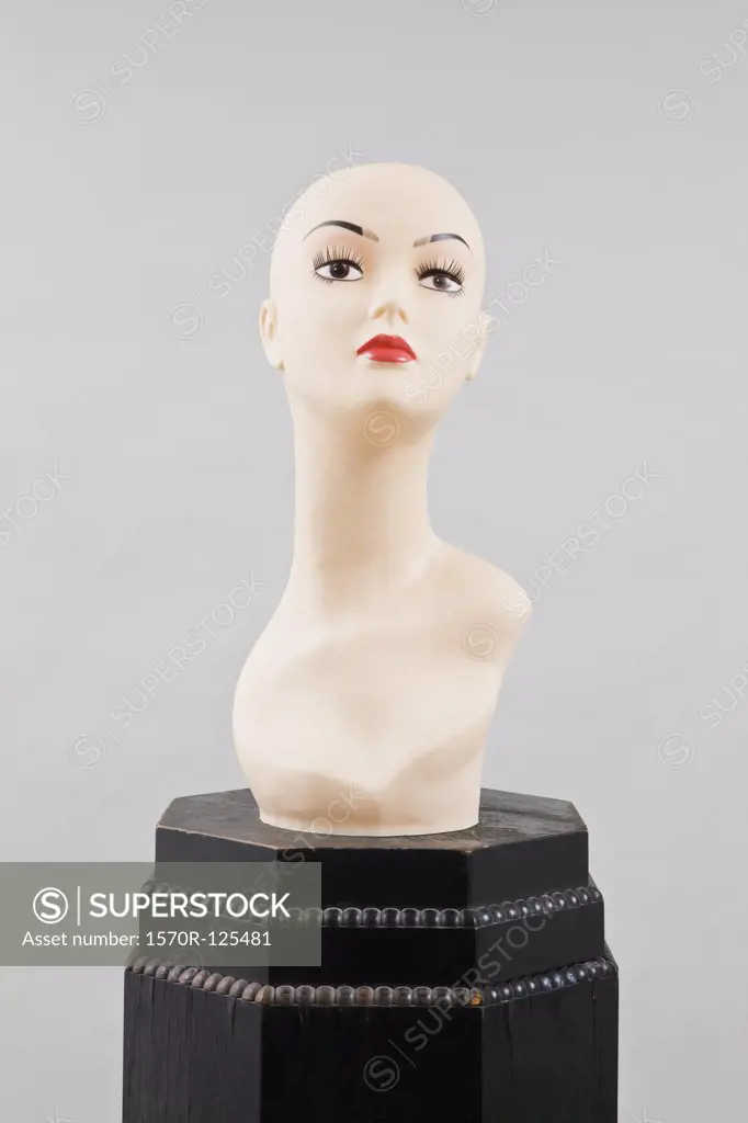 A mannequin head on a pedestal