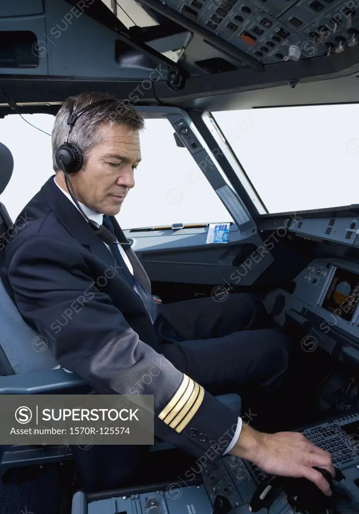 A pilot in the cockpit of a commercial plane