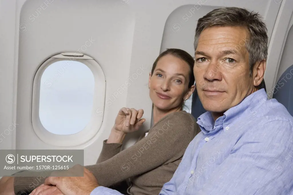 A couple sitting on a plane