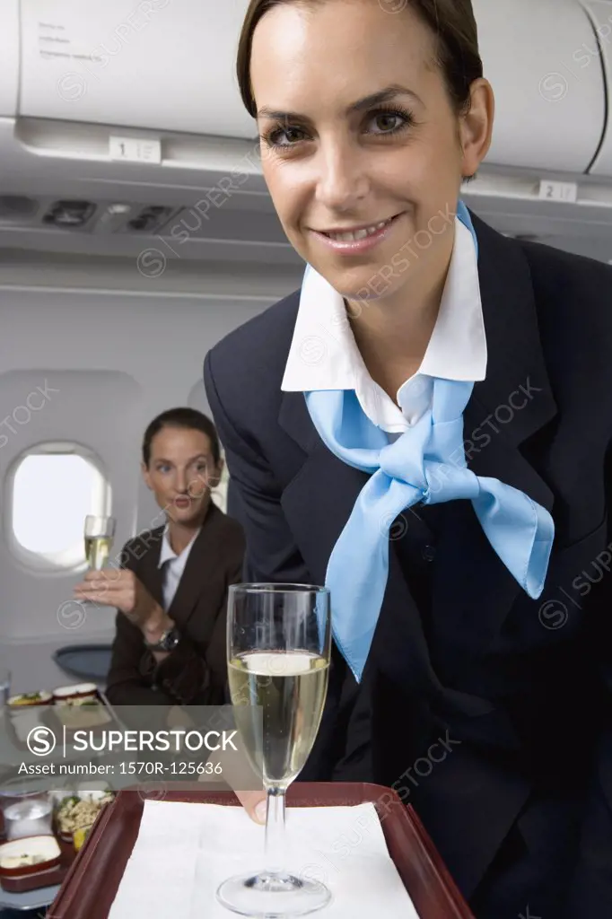 A flight attendant serving champagne