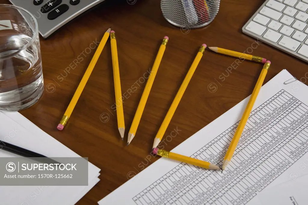 Pencils on a desk arranged to spell No