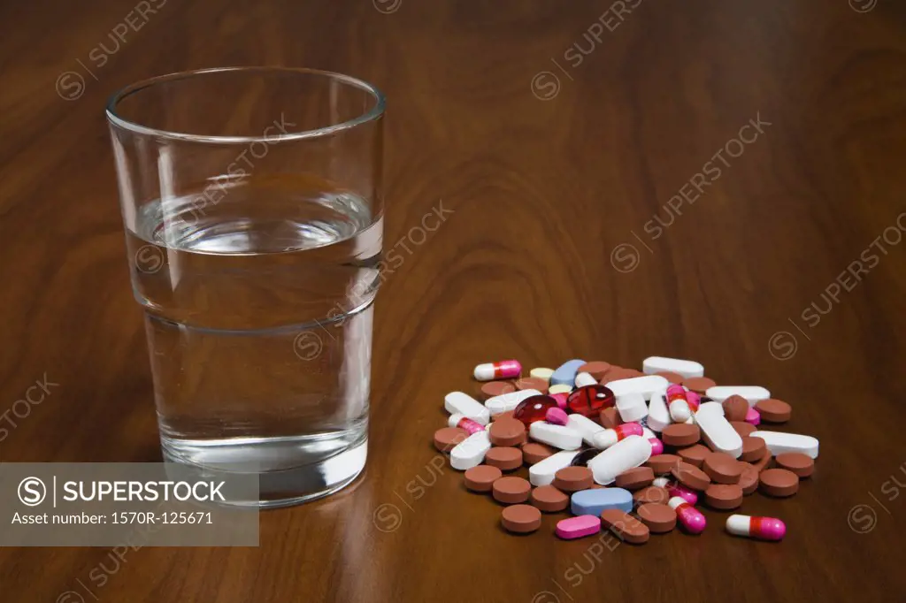 Pills next to a glass of water