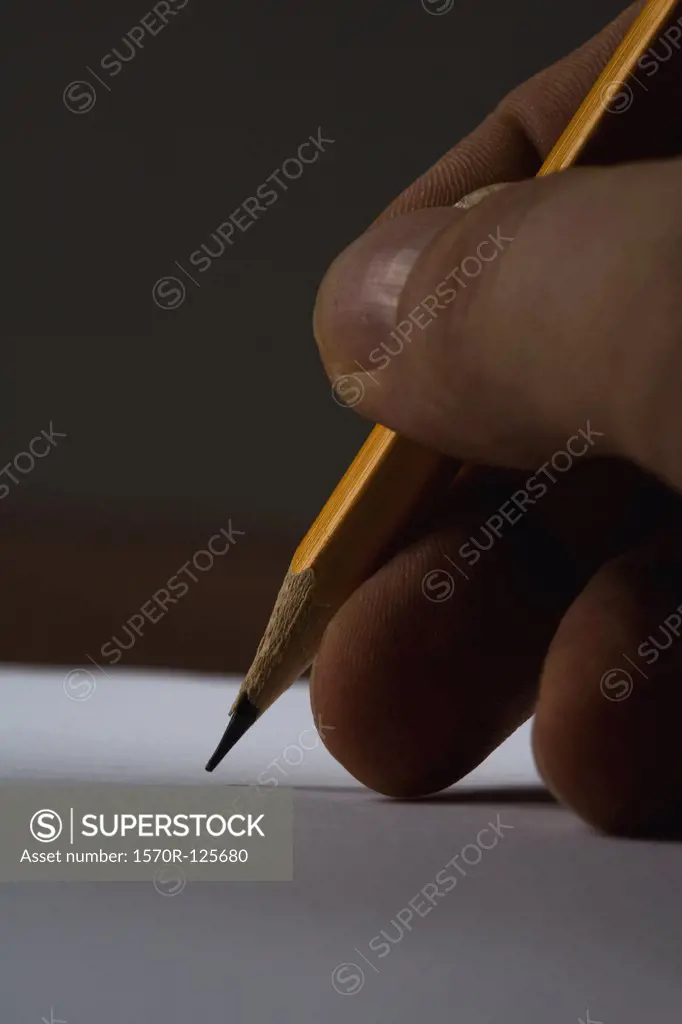 Extreme close-up of a handing holding a pencil