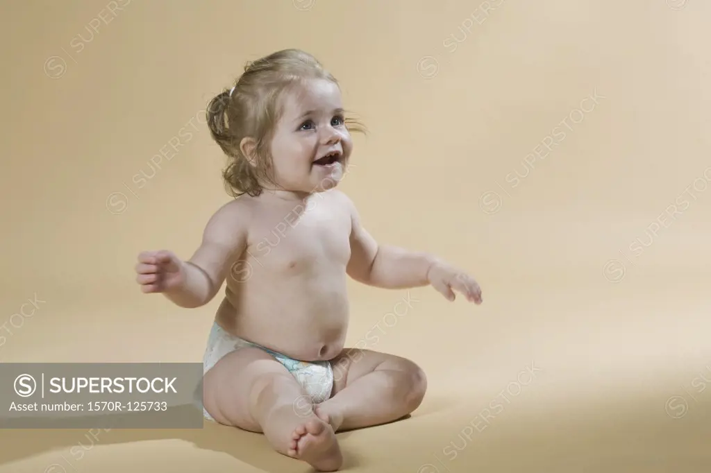 A young girl wearing a nappy