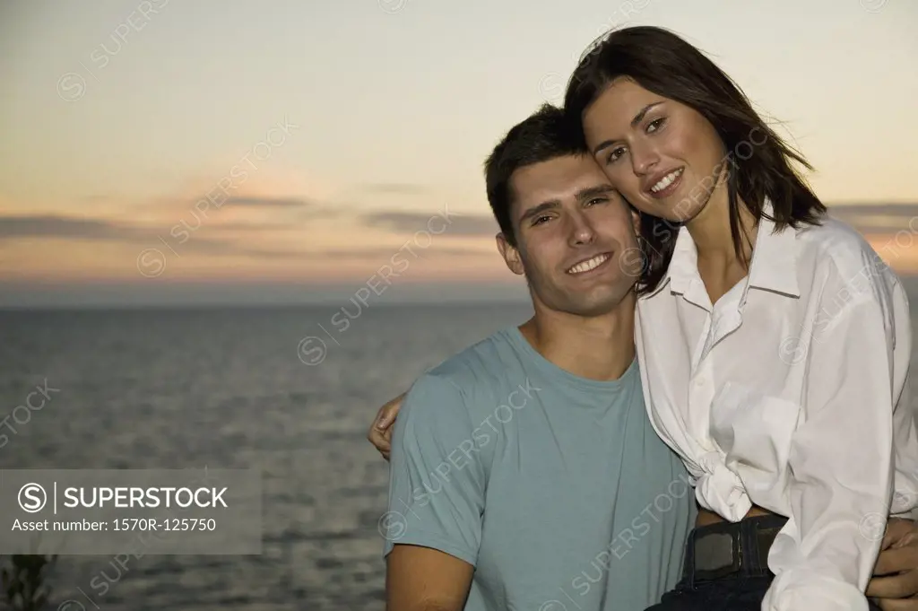 A young couple relaxing by the sea