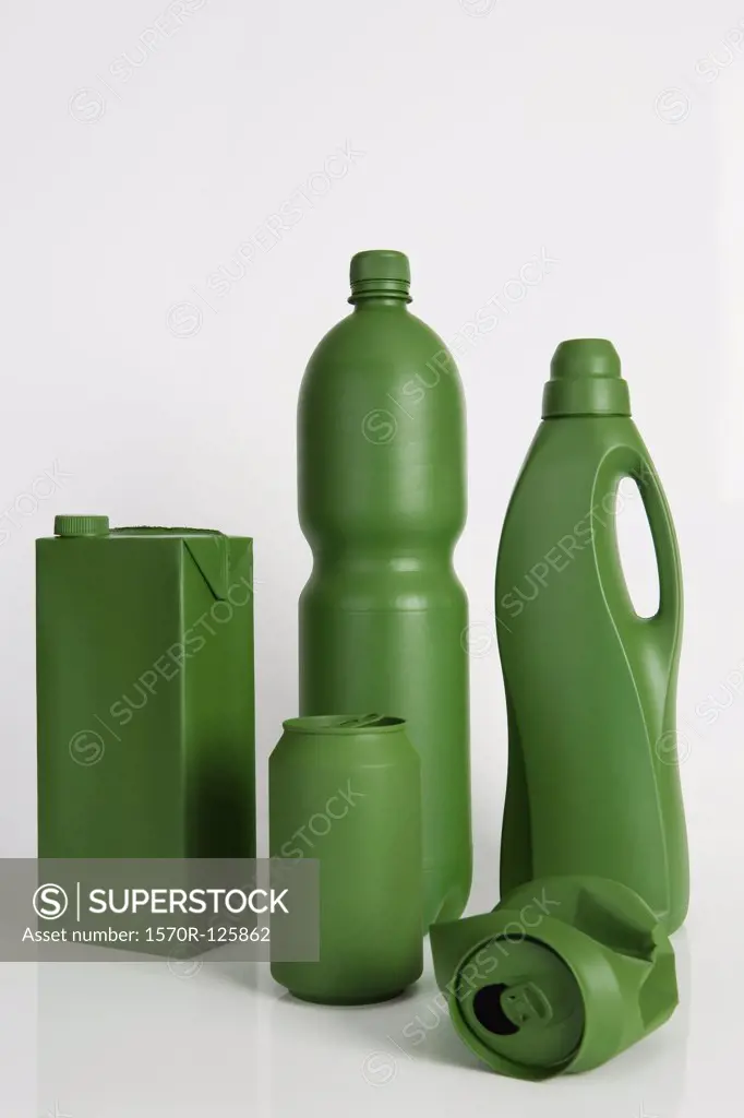 A milk carton, soda can, water bottle and laundry degerent bottle painted green