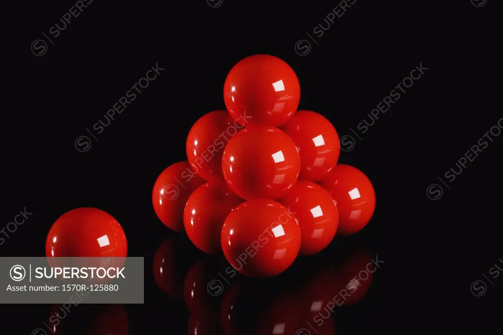 Snooker balls arranged in a pyramid shape with one aside