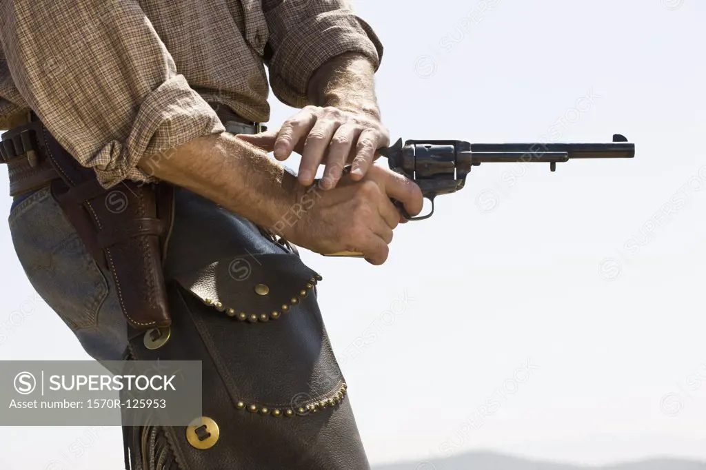 Side view of a cowboy shooting a gun