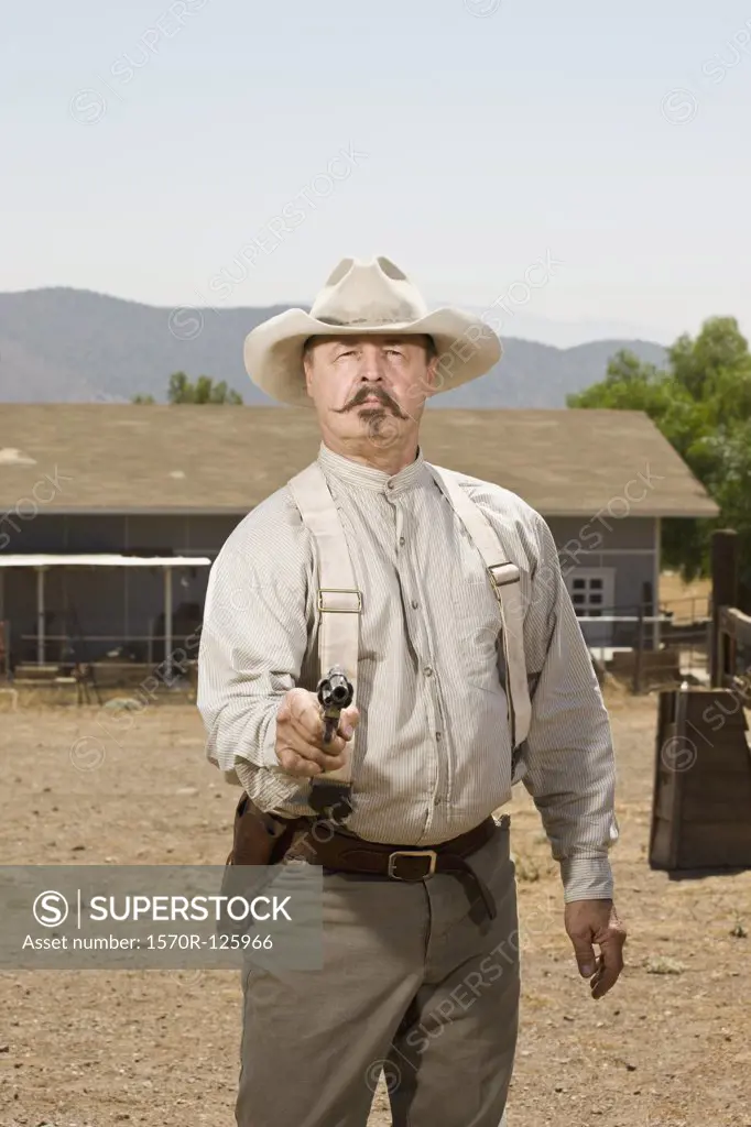 Portrait of a cowboy aiming his gun